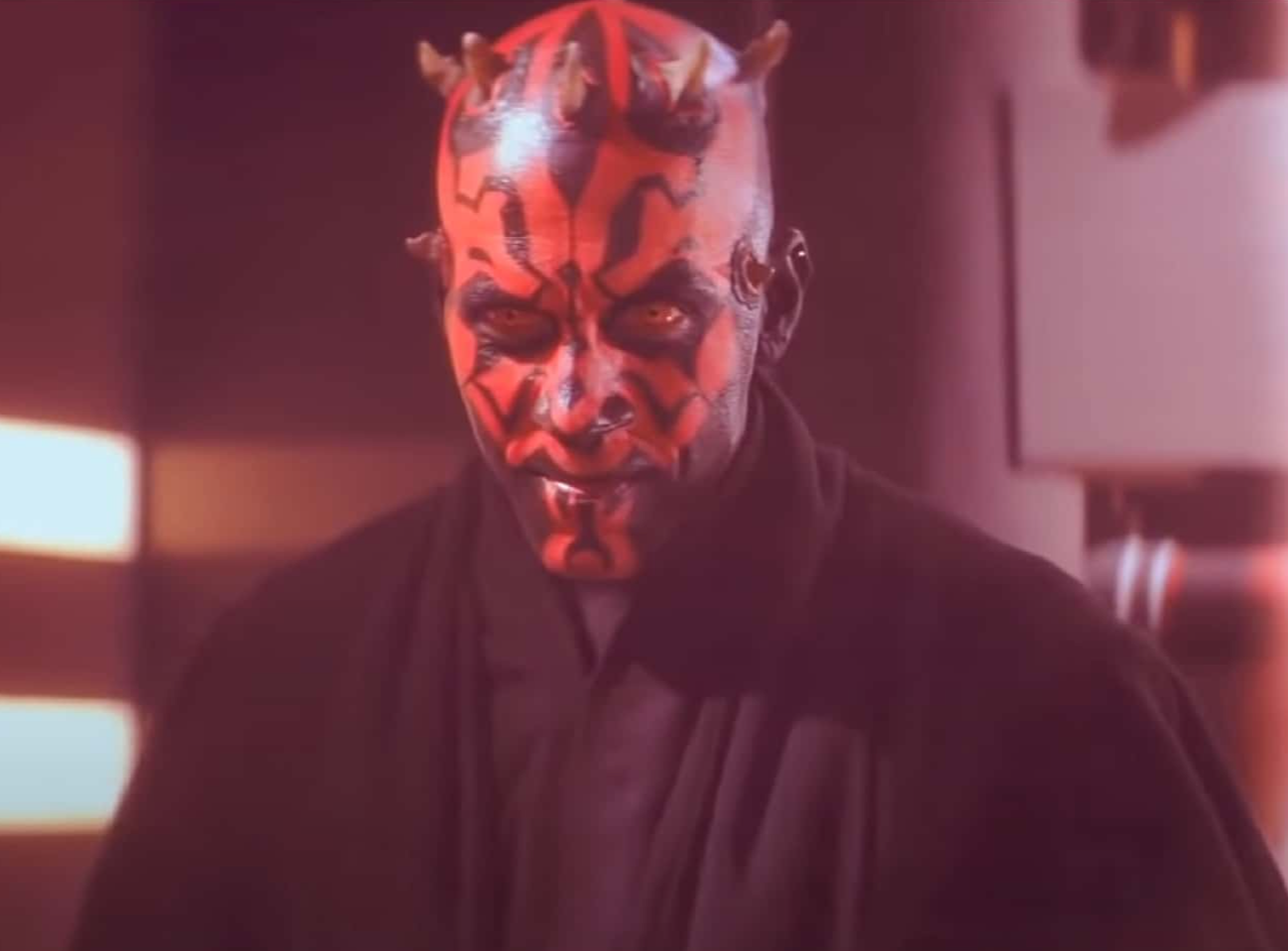Screenshot of Dart Maul with black coat looking at camera - from Star Wars: Episode I – The Phantom Menace (1999)