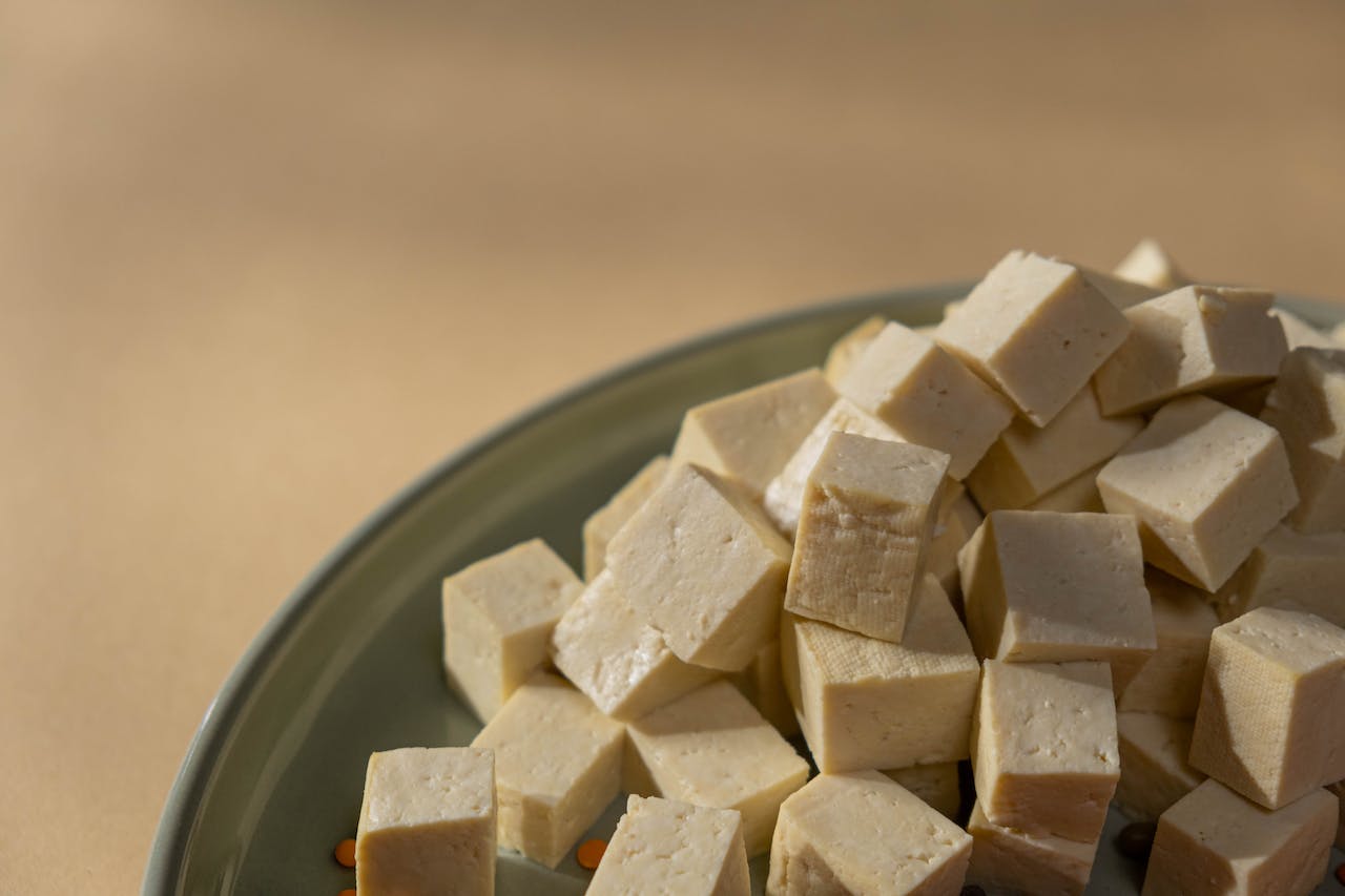 Tofu sliced in cubes on plate.