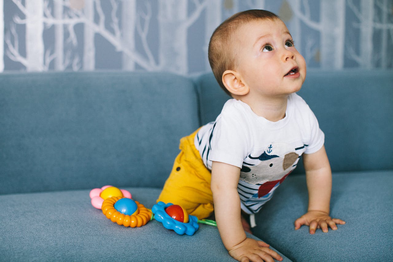 Kid playing on the bed.