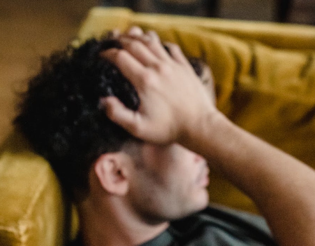 Man holding his head.