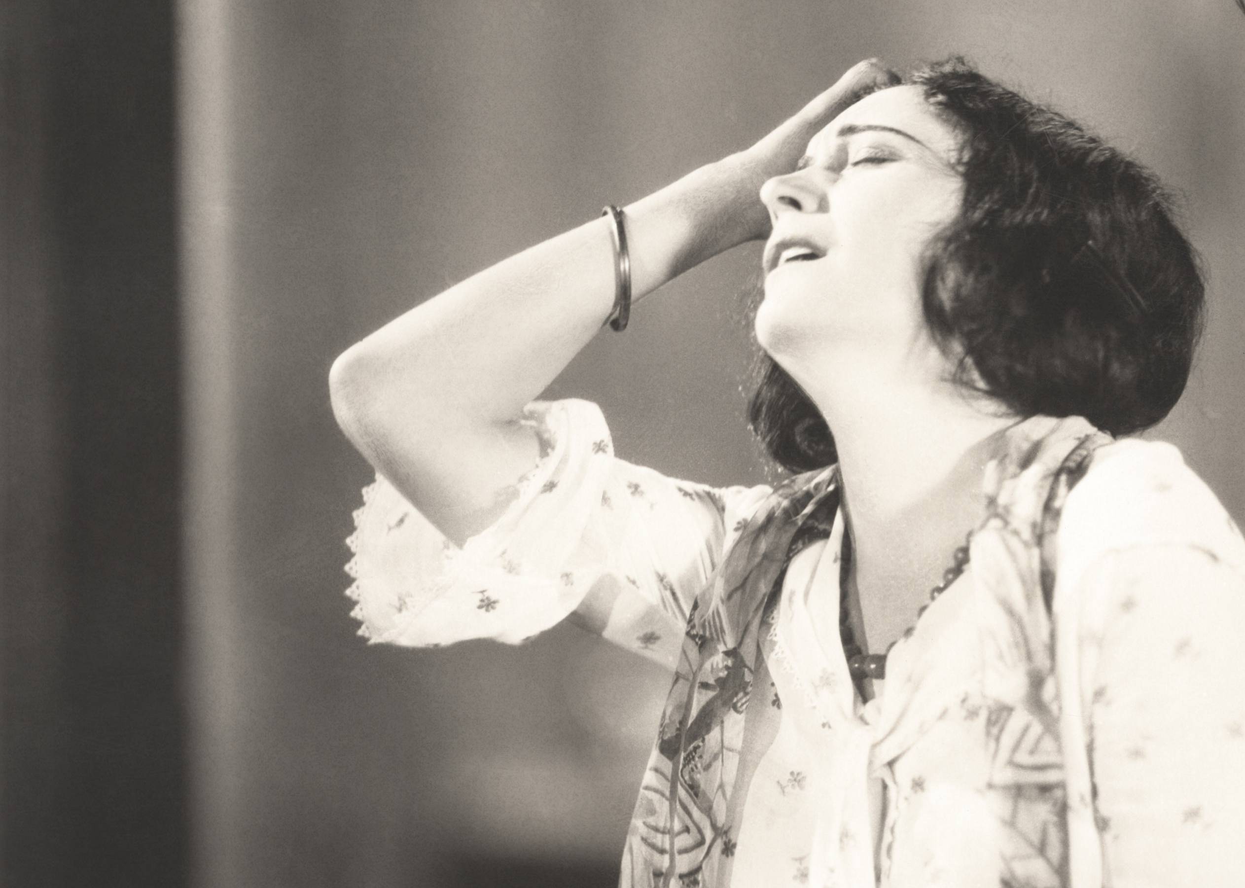 Woman in 1920's crying wearing white dress