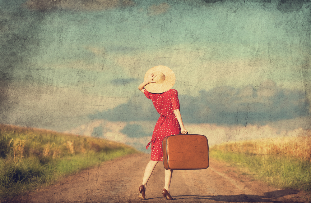 Redhead girl with suitcase at outdoor