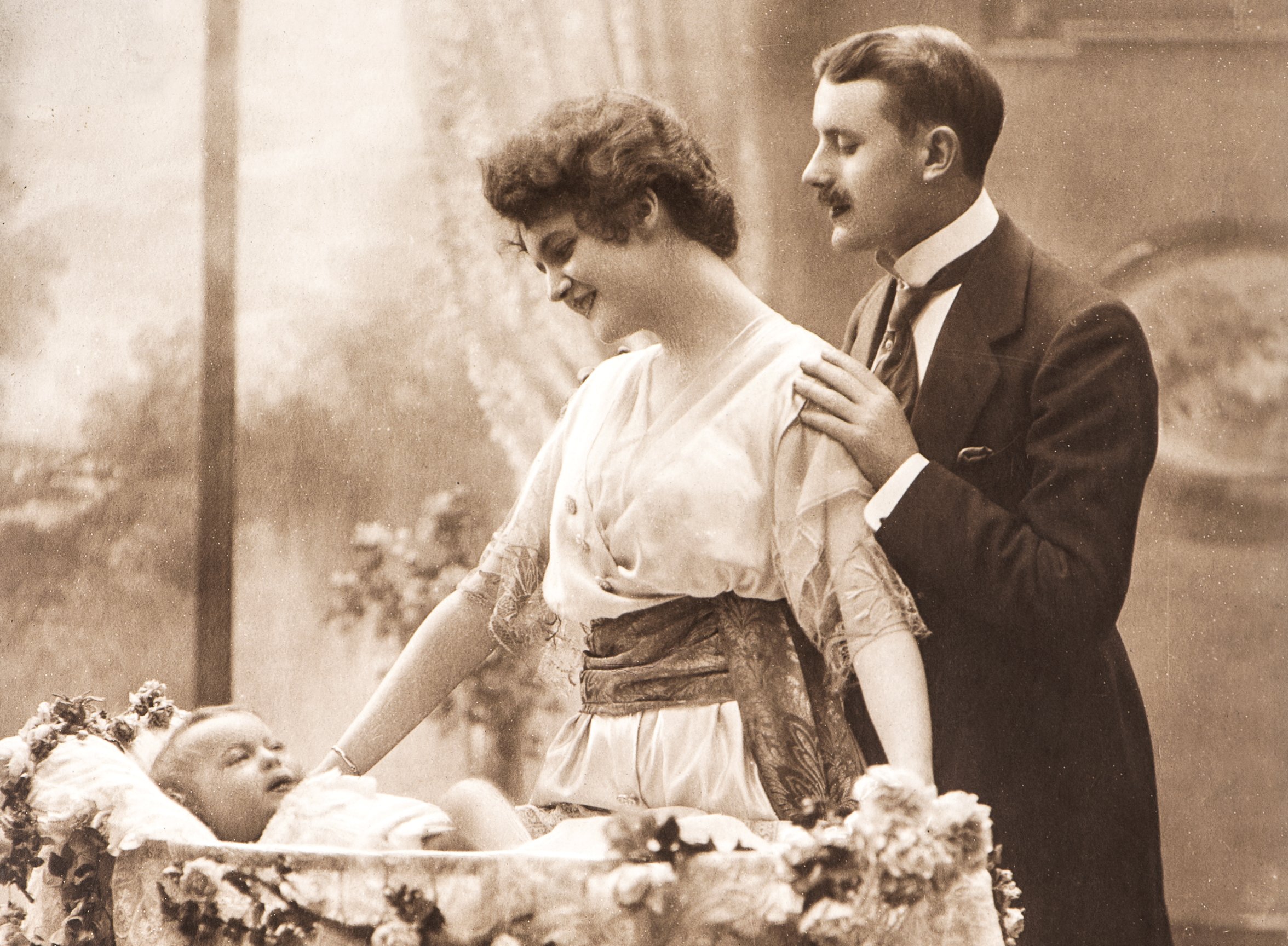 antique family portrait of mother, father and newborn baby.