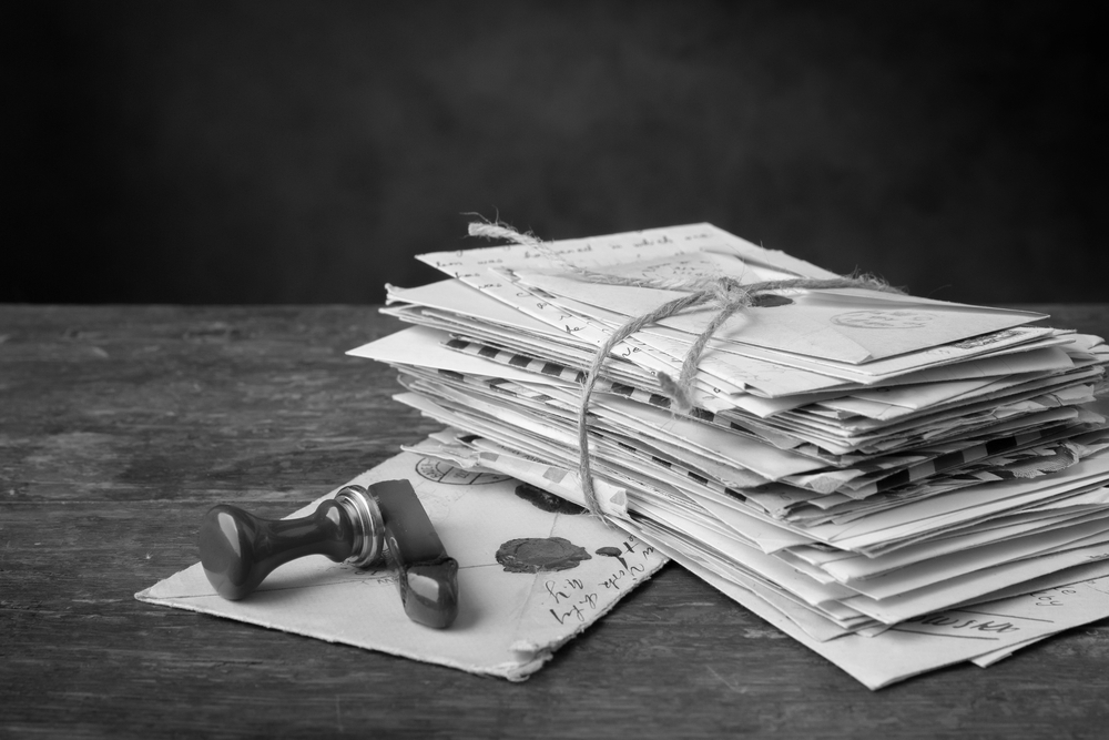 Wax seal next to a bundle of old letters