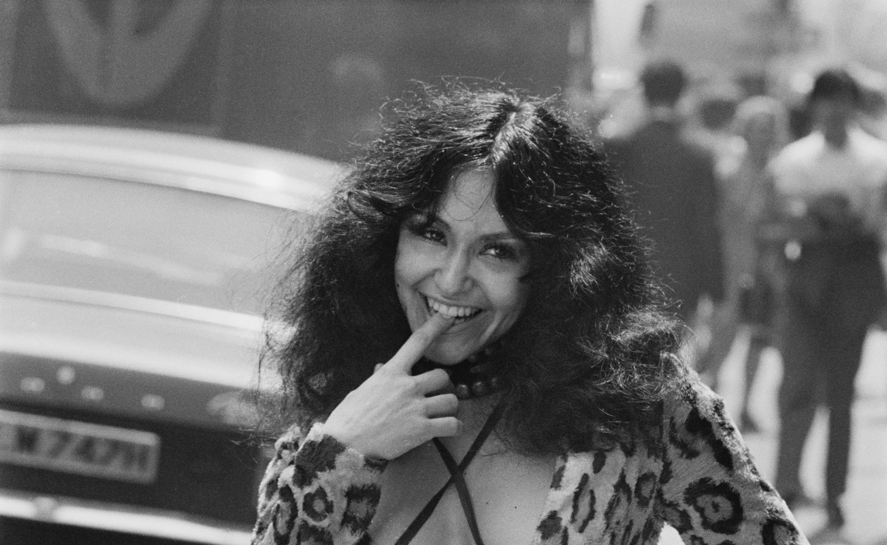 Actress Geri Miller posing in animal print dress