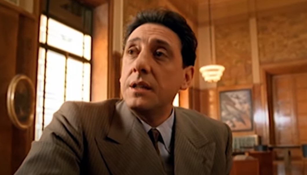 Sergio Castellitto as Enzo Ferrari in suit