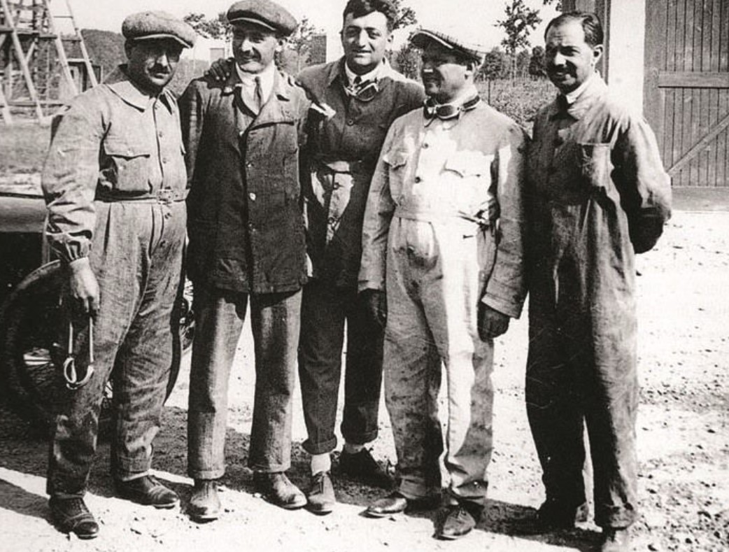 Enzo Ferrari and few others facing the camera