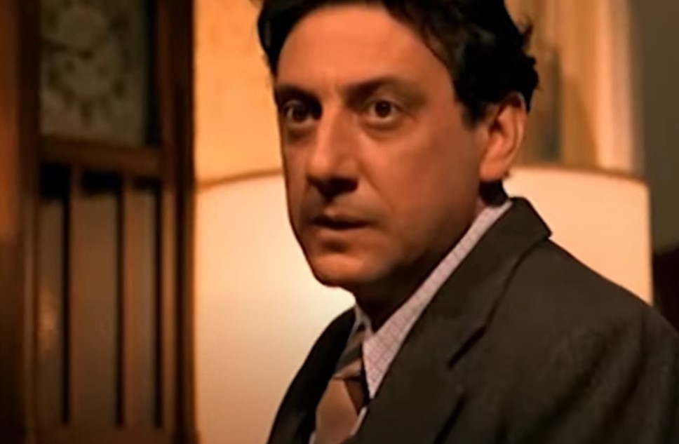 Sergio Castellitto as Enzo Ferrari in suit 