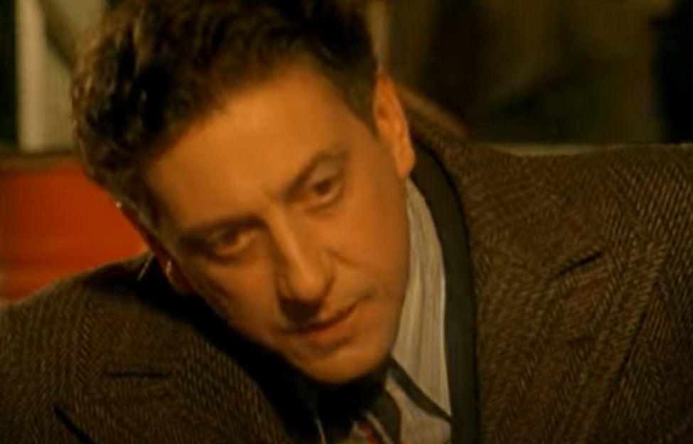 Sergio Castellitto as Enzo Ferrari in suit 