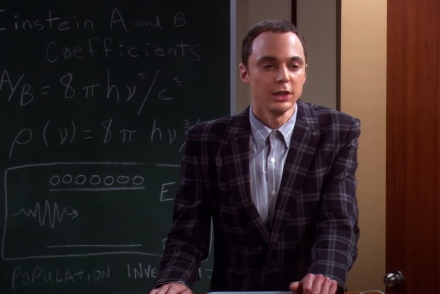 Sheldon in plaid suit giving a lecture
