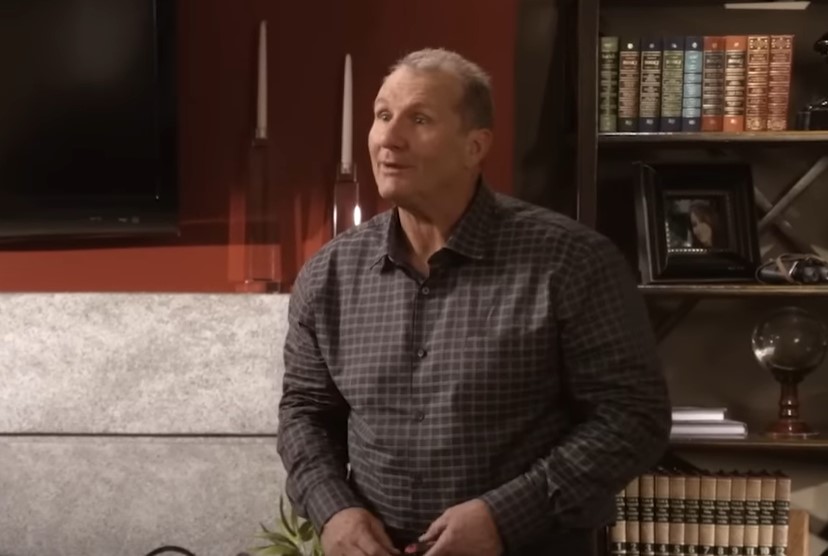 Jay (Ed O'Neill) from Modern family in library