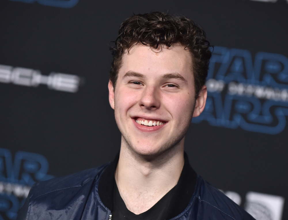 Nolan Gould arrives at an event in blue