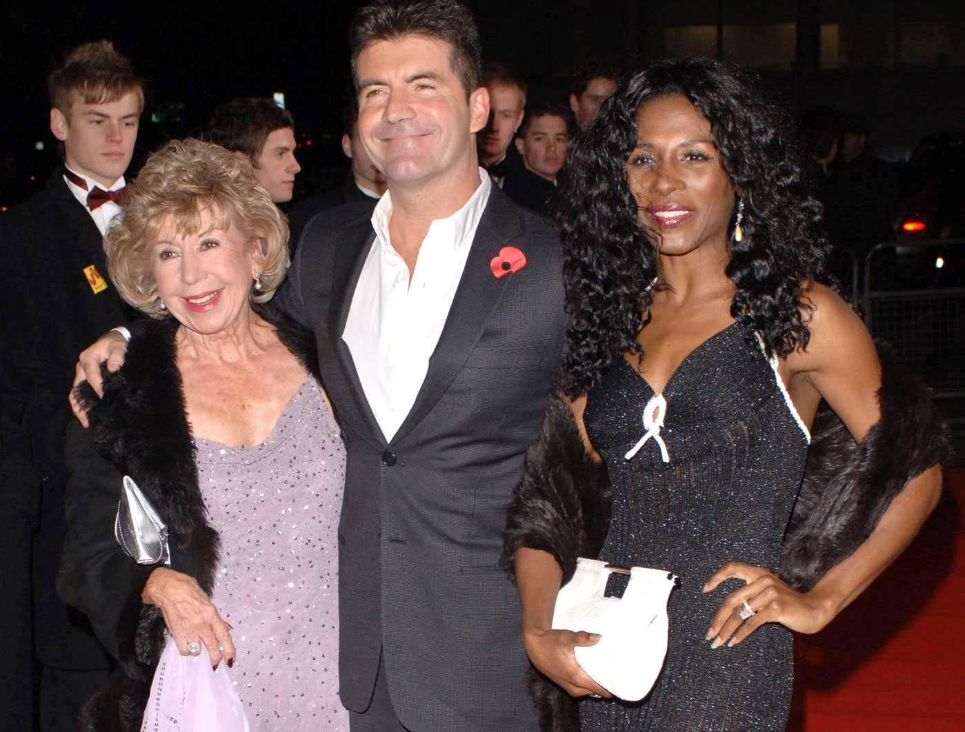 Simon Cowell arrives with his mum, Julie, (left) and Sinitta at an event