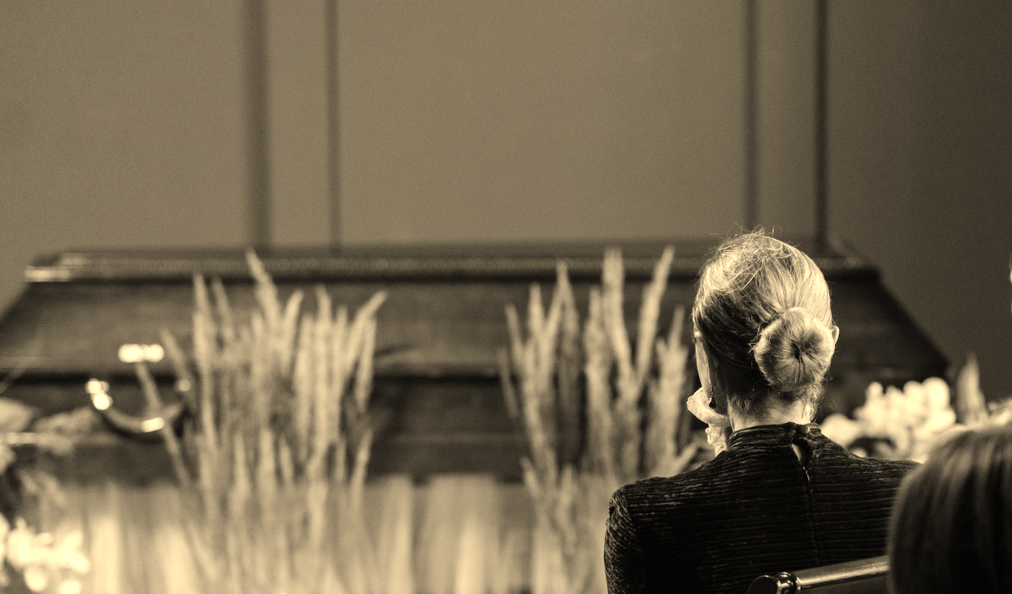 Sad people sitting on a bench in a funeral home