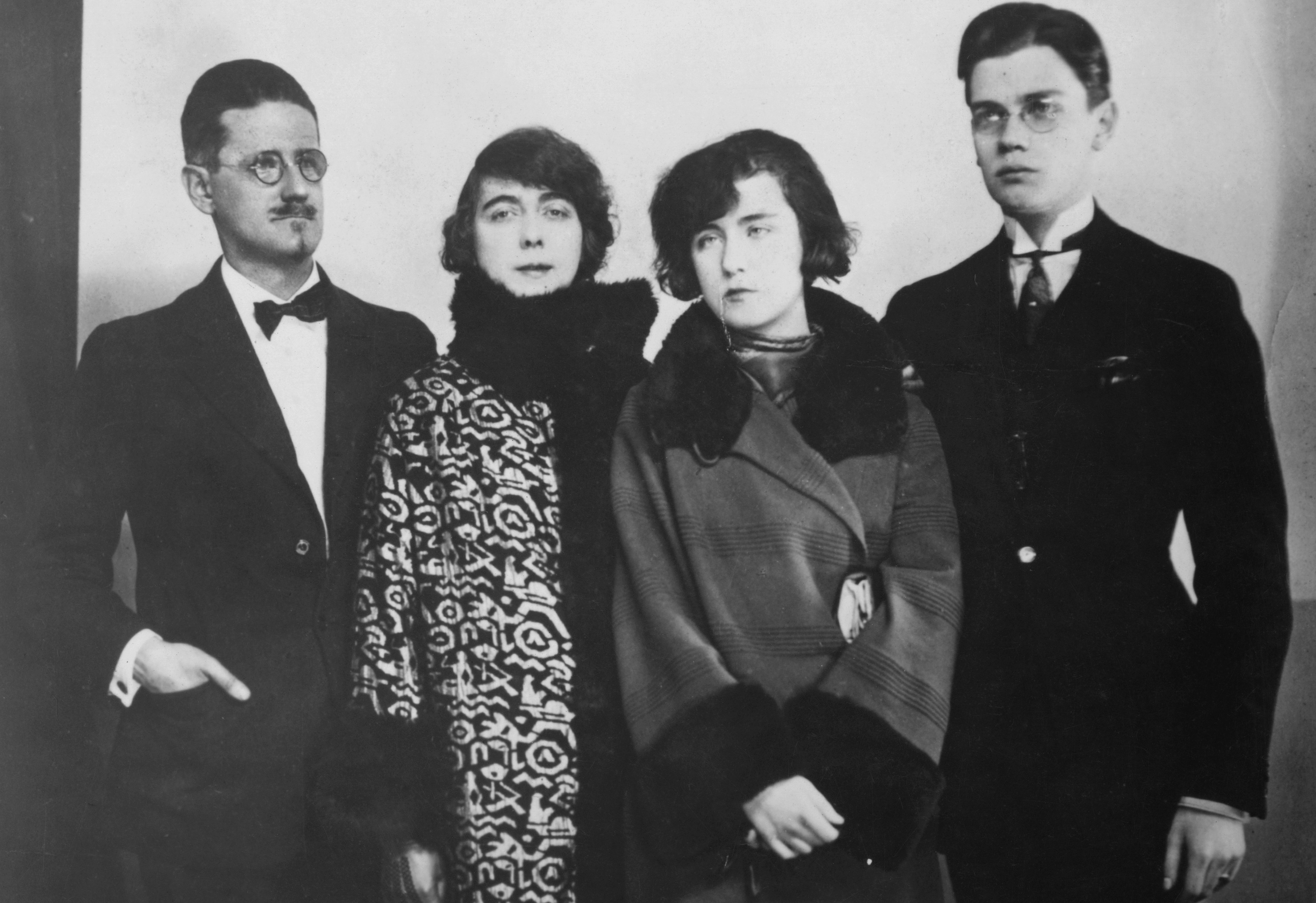 Irish novelist and poet James Joyce (1882 - 1941, left) with his family