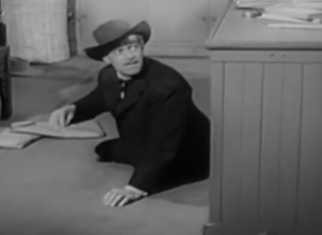 Screenshot of Black Bart (Arthur Space) seating on the floor - from Stories of the Century (1954-55)