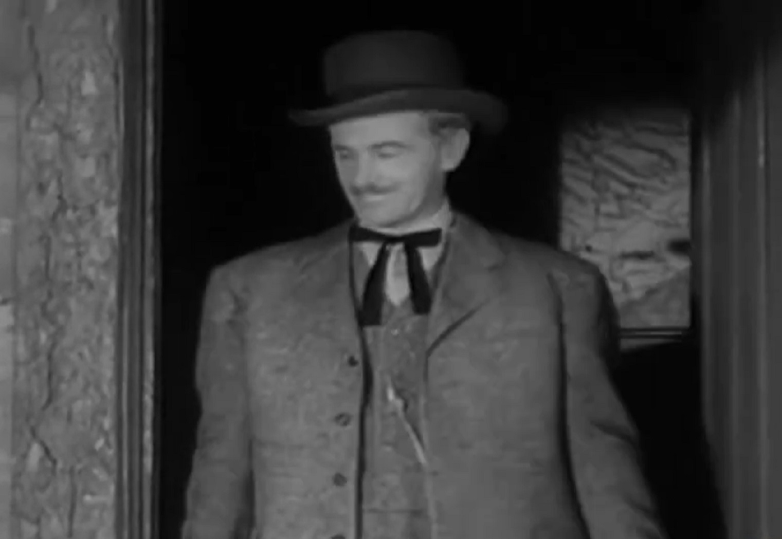 Screenshot of Black Bart (Arthur Space) walking outside in black suit - from Stories of the Century (1954-55)