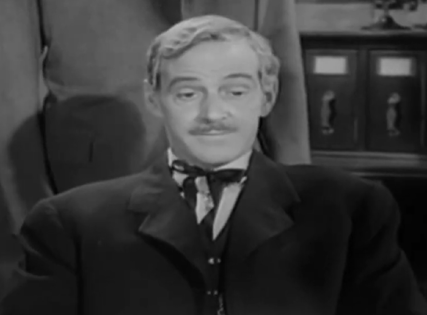 Screenshot of Black Bart (Arthur Space) seating on chair - from Stories of the Century (1954-55)