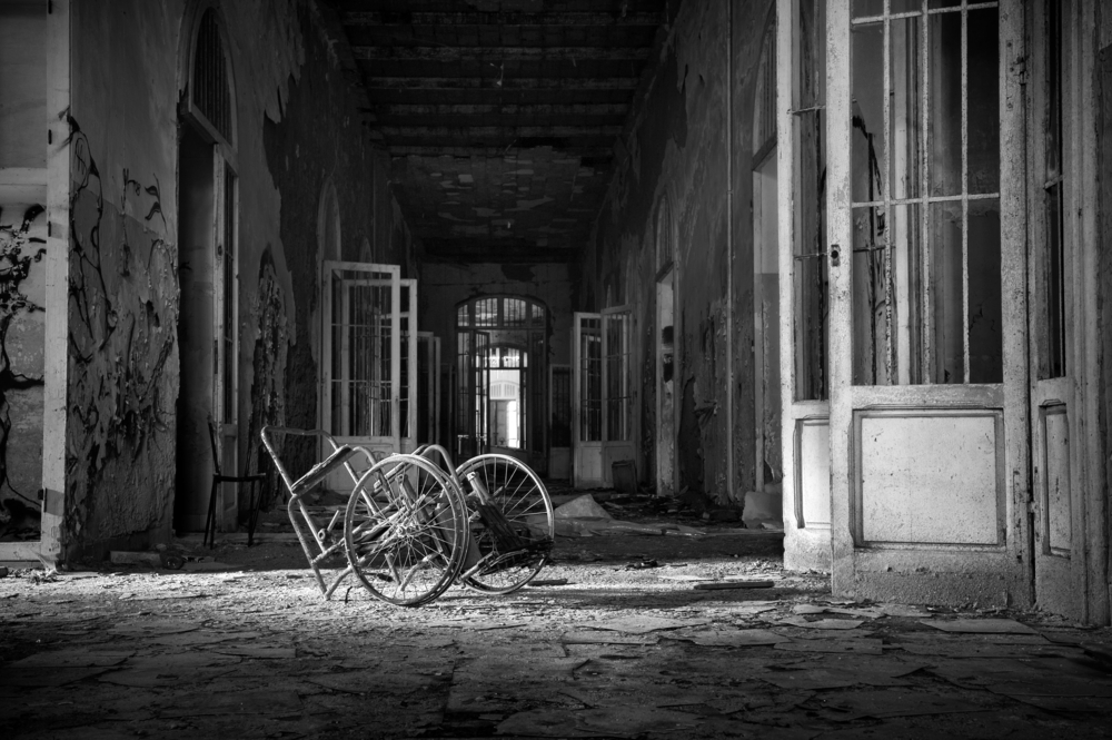 View of a room with wheelchair abandoned in the Psychiatric Hospital of Volterra in Tuscany