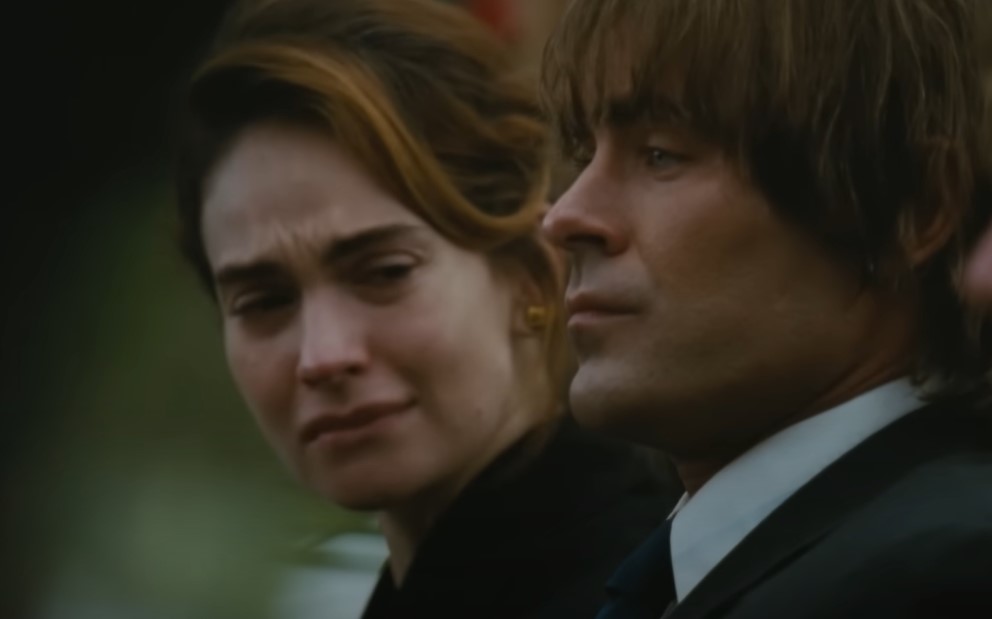 Zac Efron as Kevin Von Erich in The Iron Claw at a funeral