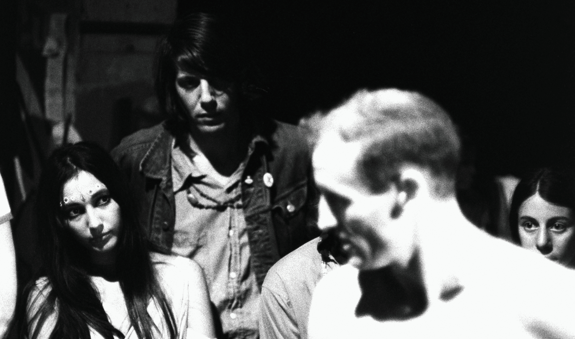 woman looks at the shirtless Neal Cassady