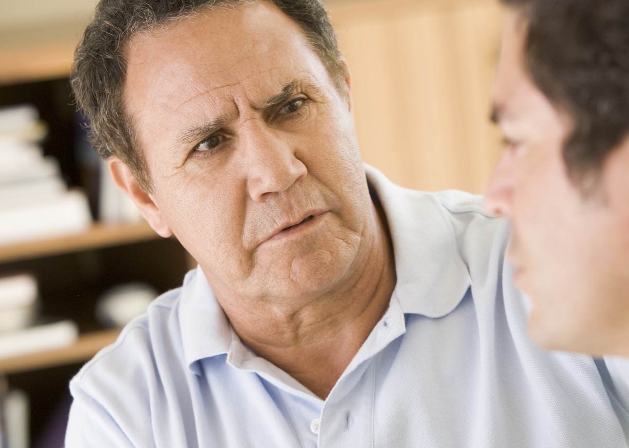 Two men in living room talking