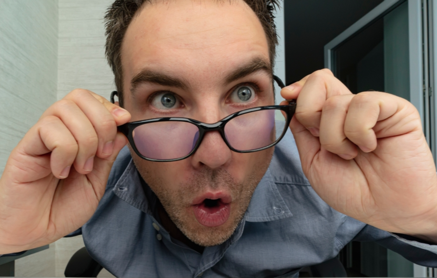 Shocked man in office looking at his computer