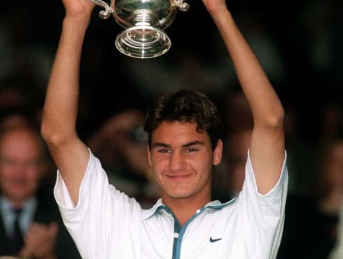 Roger Federer of Switzerland holds aloft the Boys Singles trophy