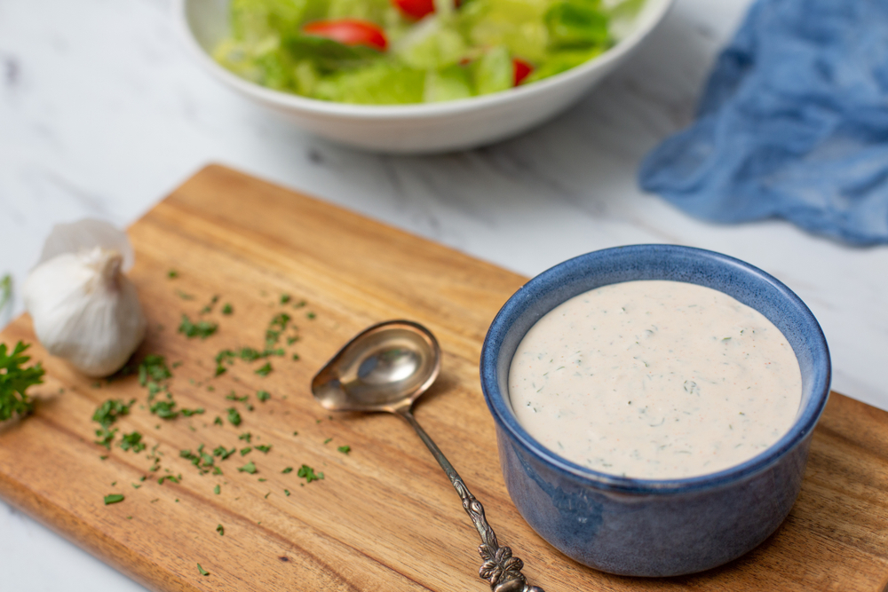 Homemade Buttermilk Ranch Dressing in Blue Bowl on White Countertop;