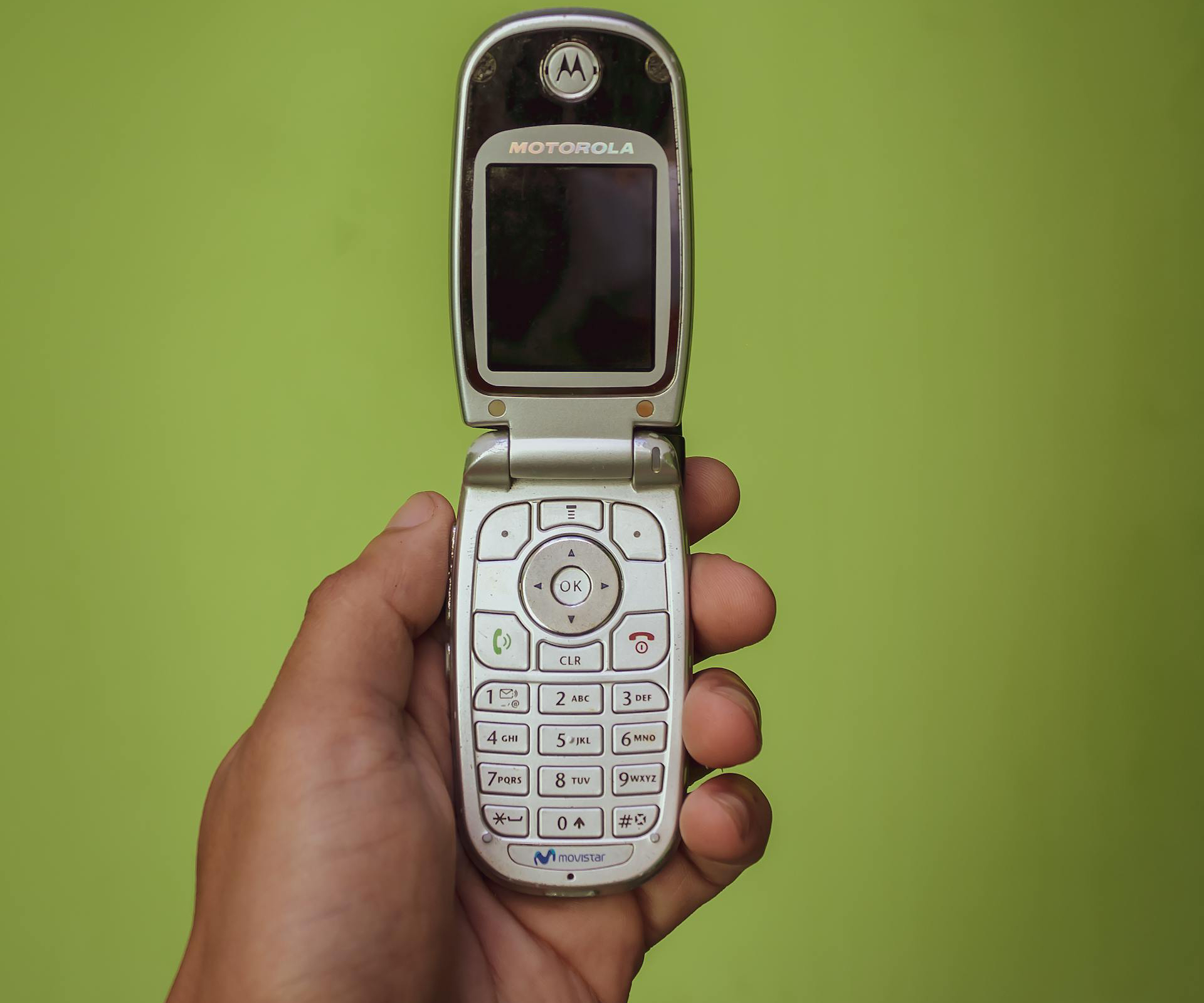a person holding old cellphone