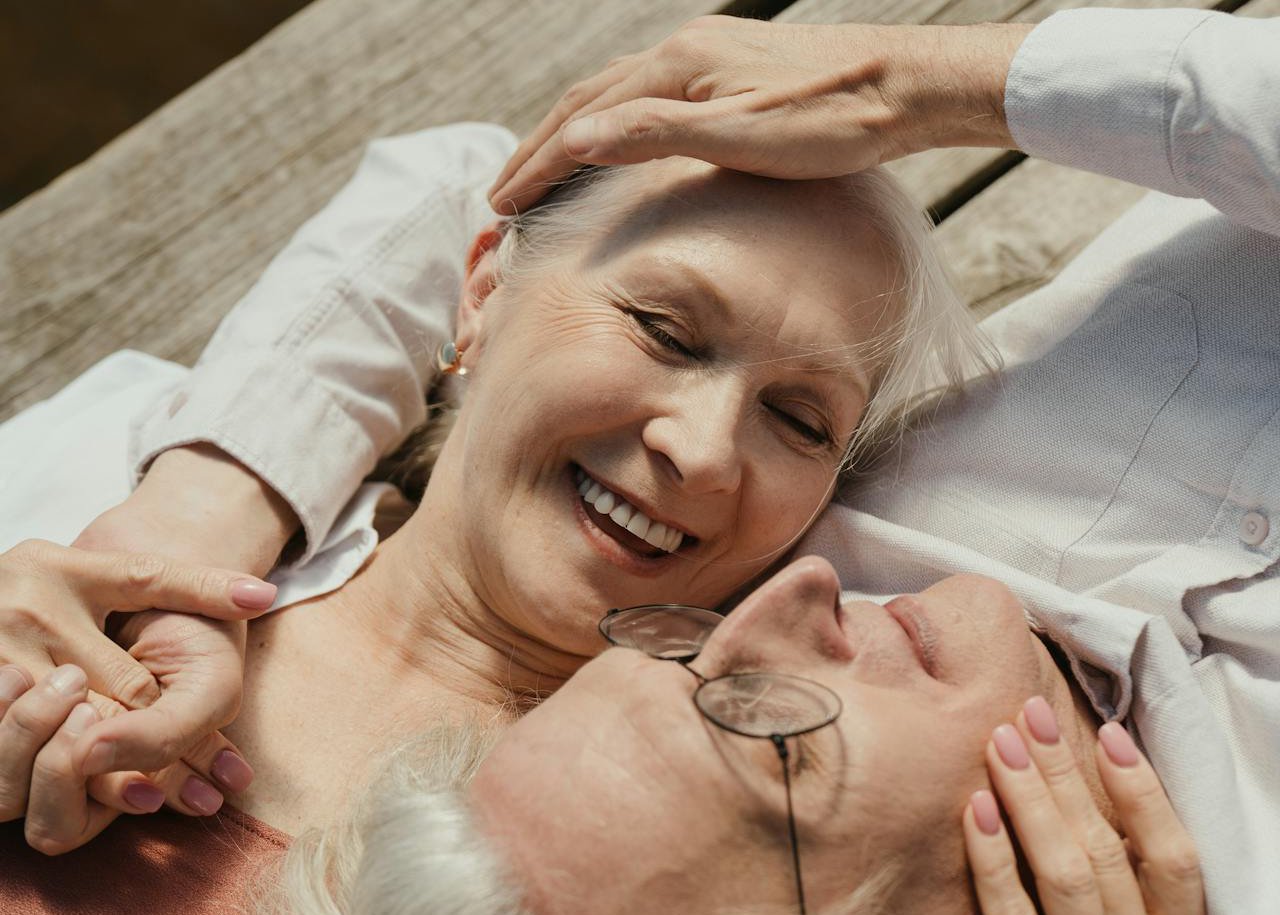 An elderly couple lying