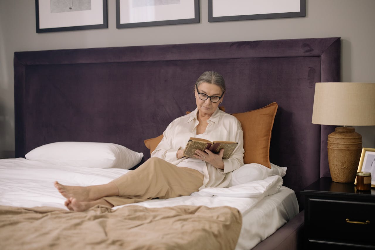 Elderly woman sitting on bed