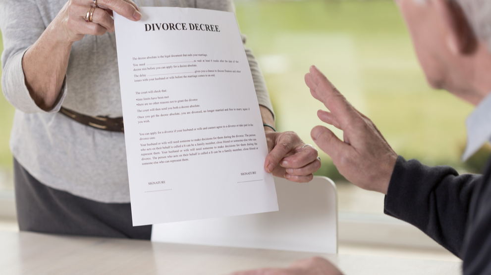 Close-up of female hands holding divorce paper