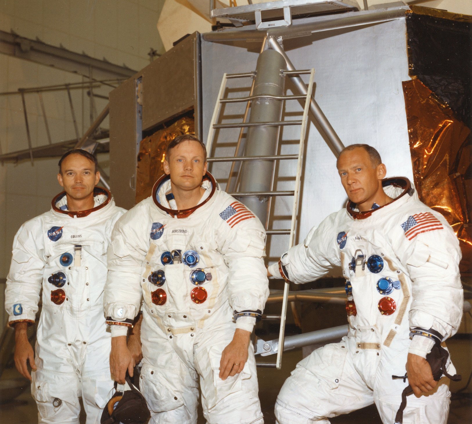 Apollo 11 astronauts in front of lunar module mockup