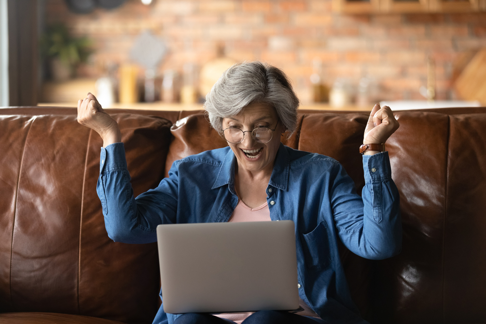 Overjoyed senior Caucasian woman celebrating a win