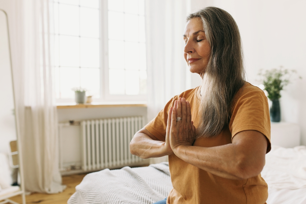 Elderly retired woman in good shape doing yoga