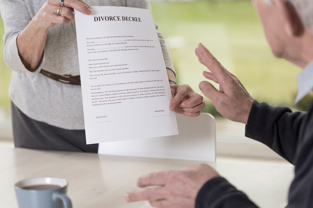Close-up of female hands holding divorce paper