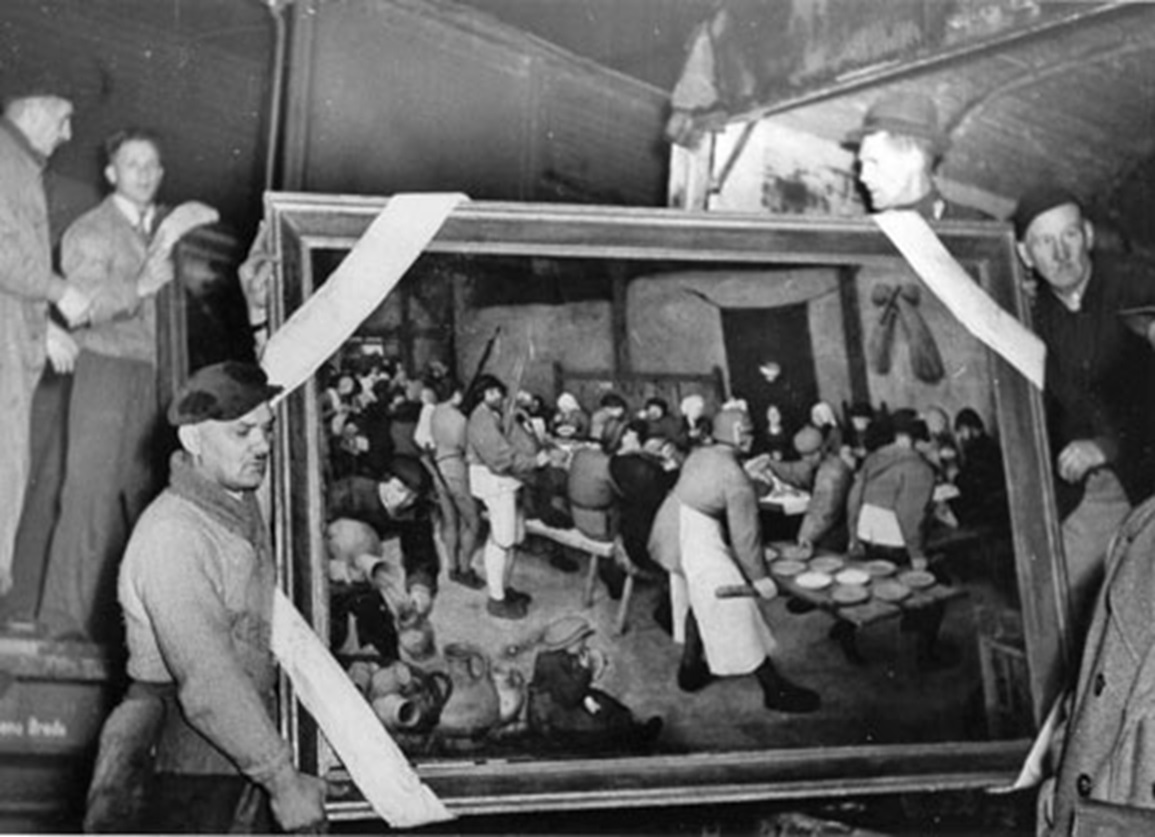 People holding painting during recovery from the Altaussee salt mine, 1945