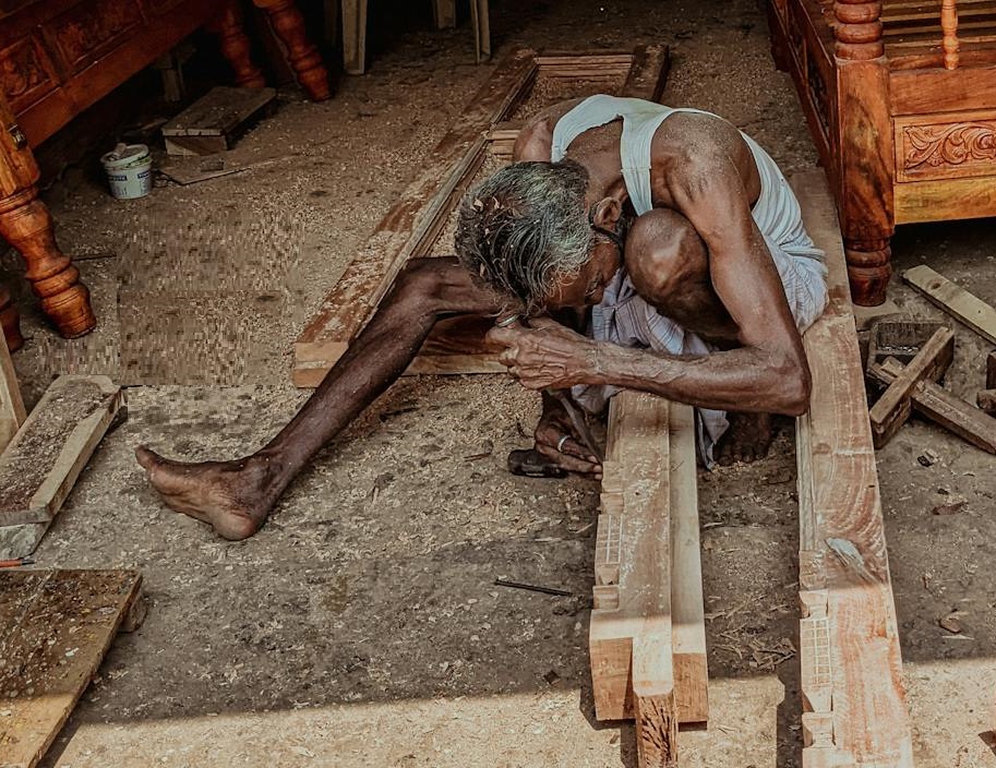 Old Man Working with Wooden Building Materials