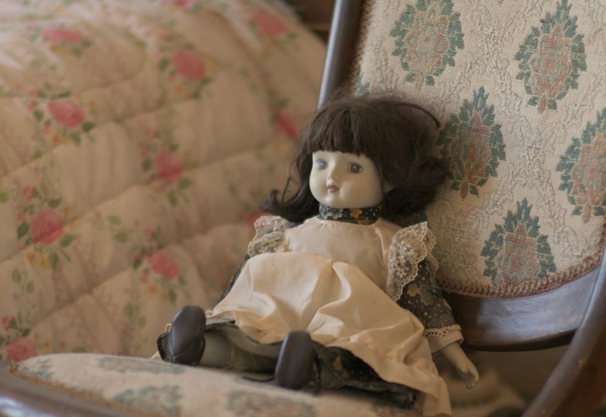An Old Doll on a Rocking Chair