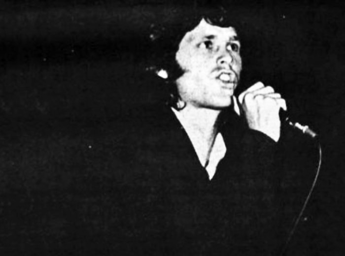Jim Morrison singing on a microphone