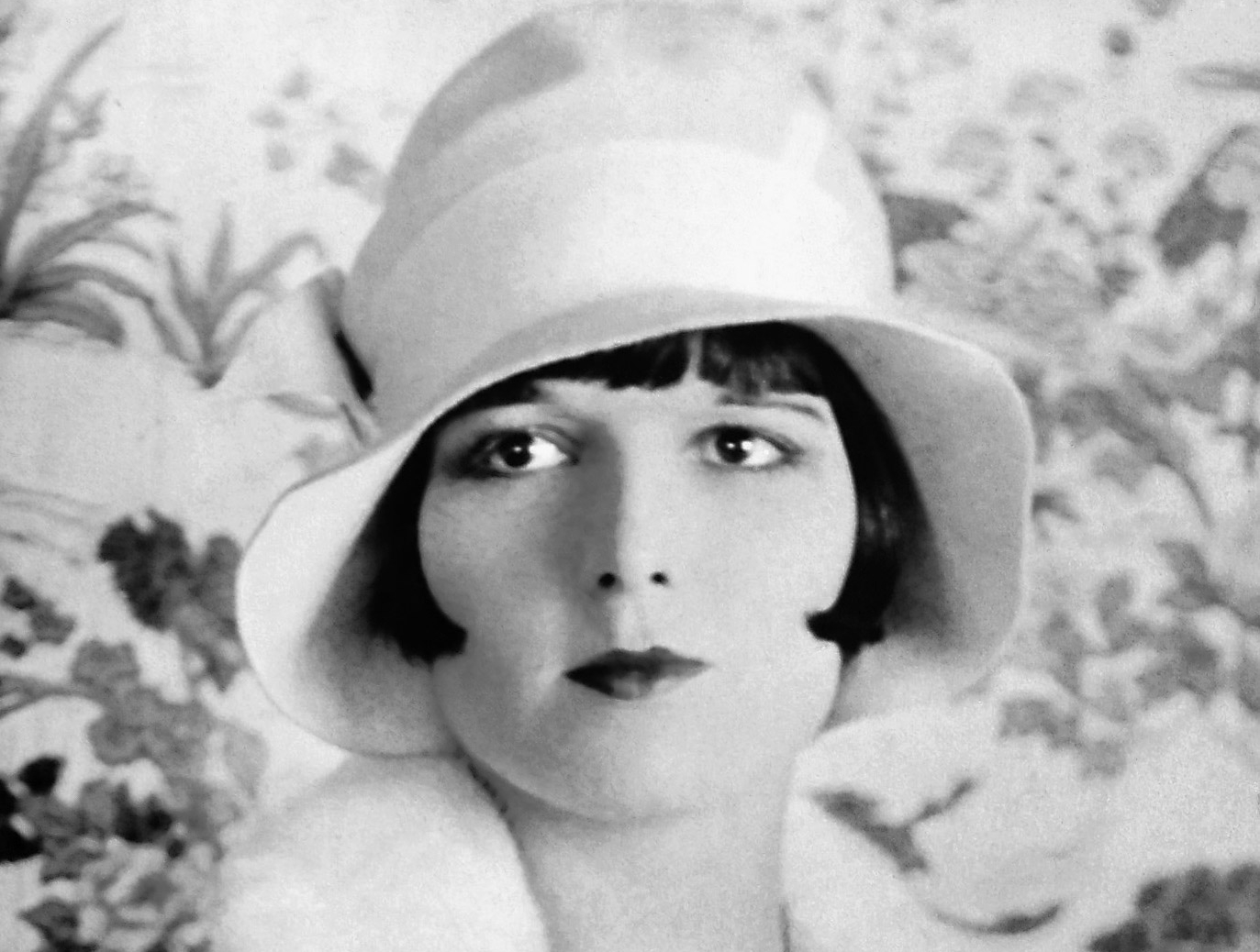 Louise Brooks  in hat and coat