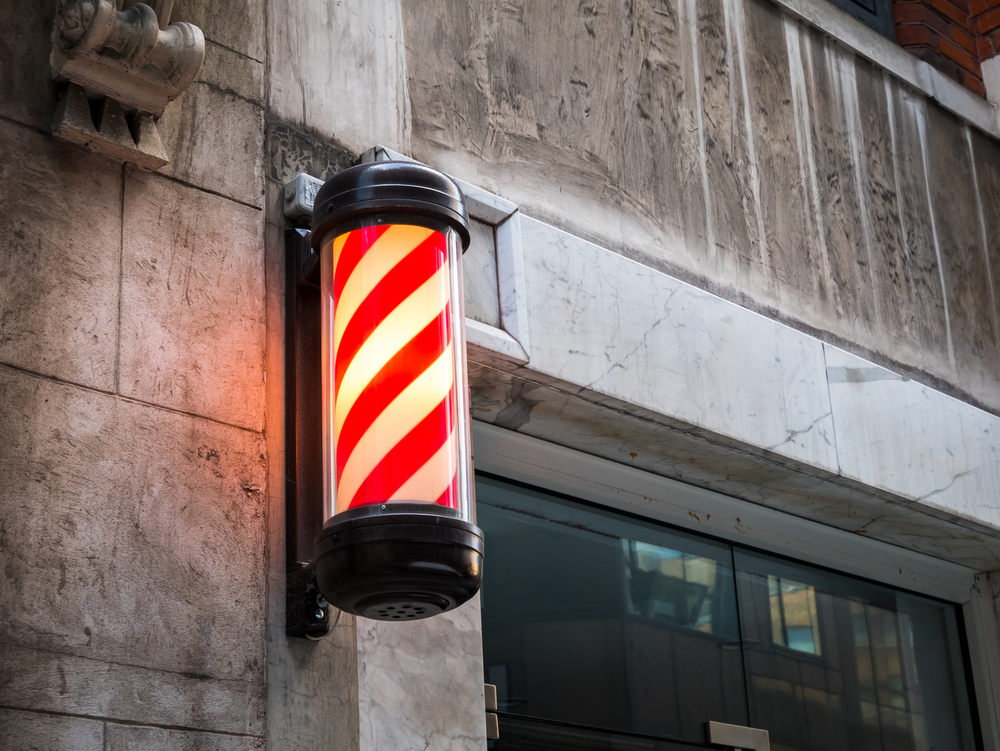 Barber shop pole in red and white spiral stripes