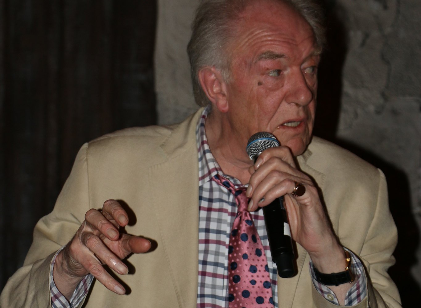 Michael Gambon wearing a cream jacket