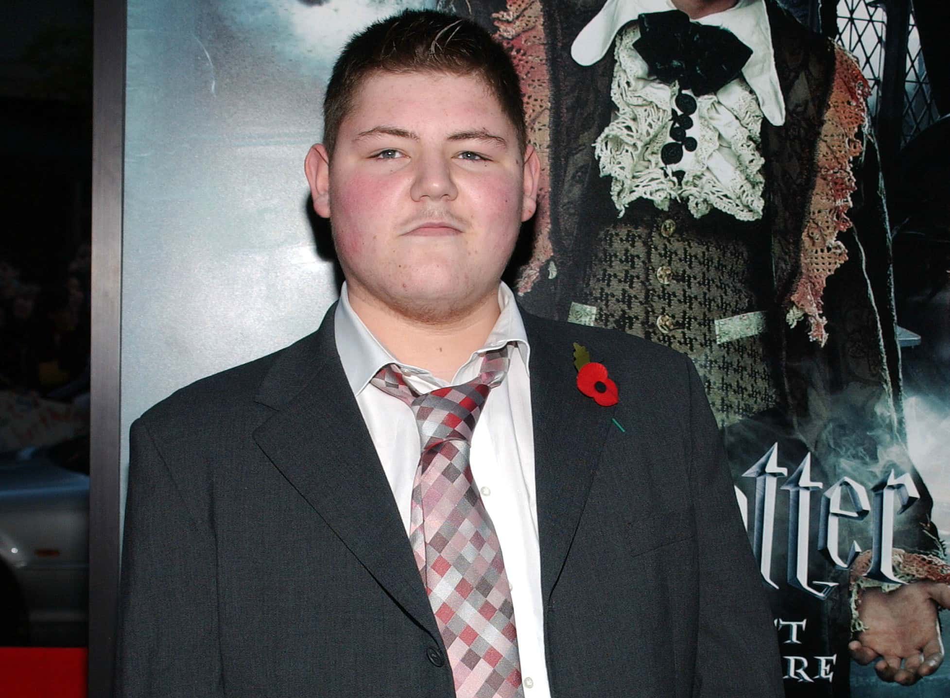 Actor Jamie Waylett wearing a suit