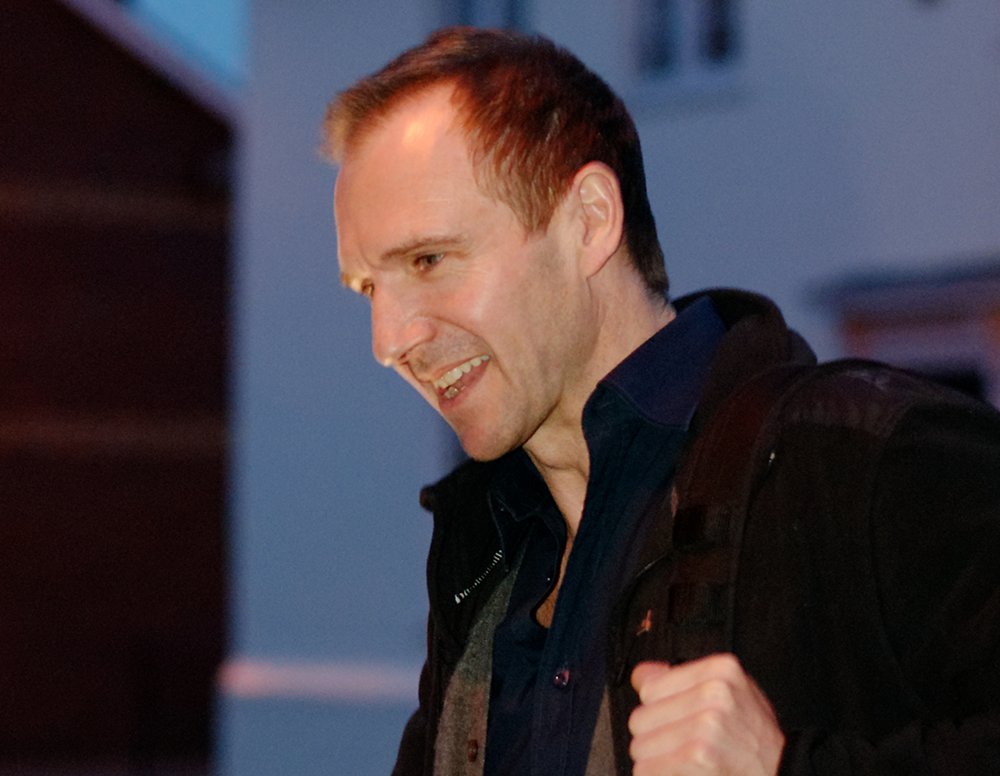 Ralph Fiennes wearing a black jacket