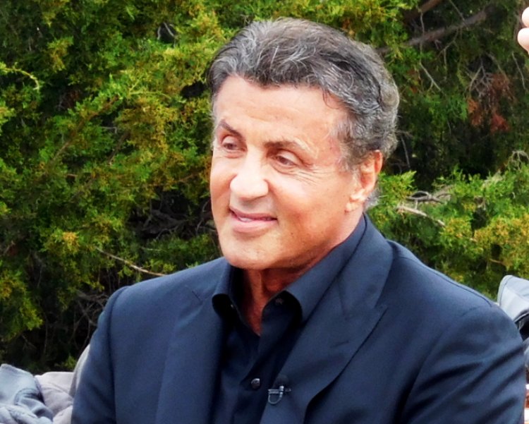 Sylvester Stallone wearing a black suit
