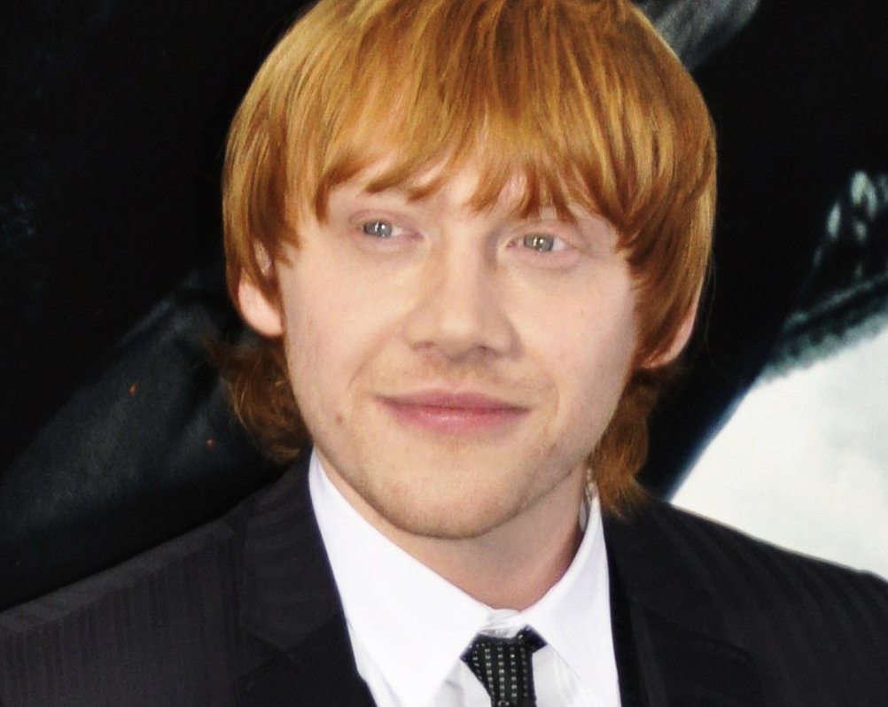 Rupert Grint wearing a black suit