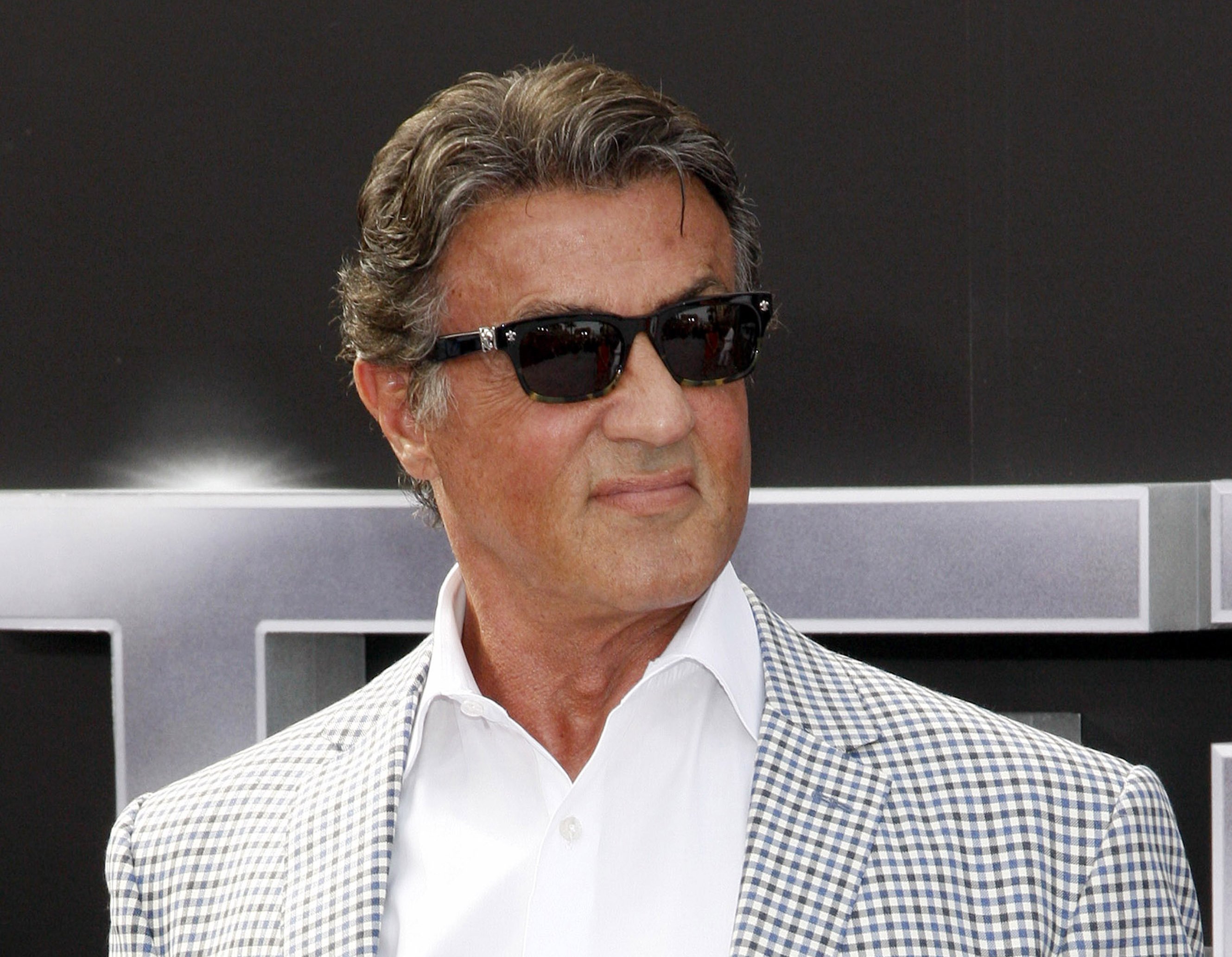 Actor Sylvester Stallone wearing a white shirt