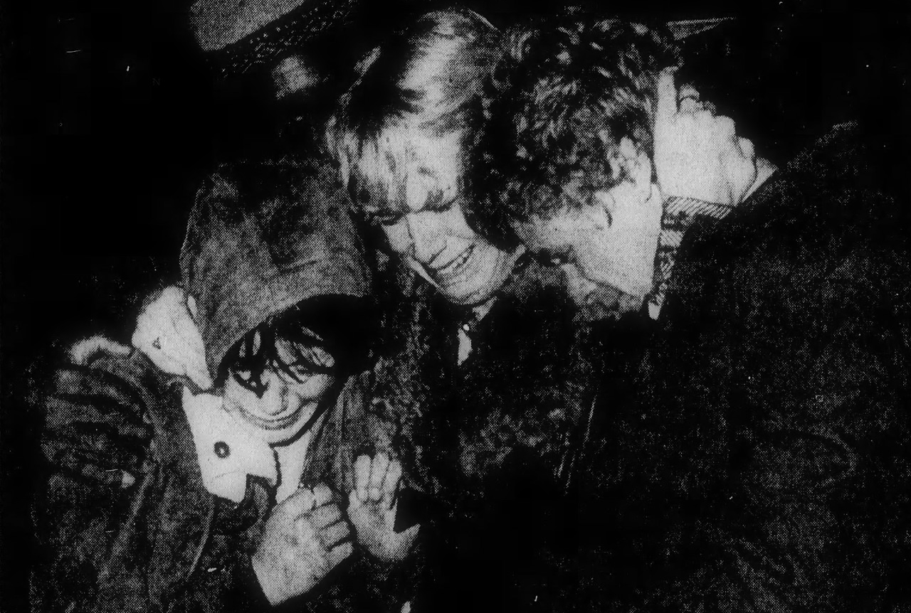 People weep on the plaza outside after the coliseum deaths